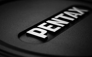 Pentax logo embossed on black surface