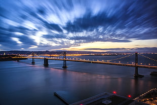 time lapse photography of bridge and cloud