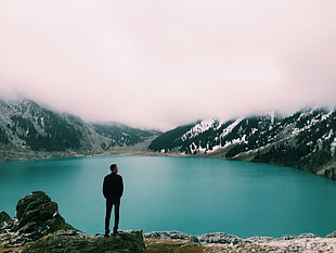 man standing in front of lake during daytime HD wallpaper
