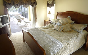 brown wooden bed frame with bed mattress