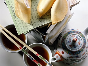 white and multicolor ceramic teapot and cups with chopstick