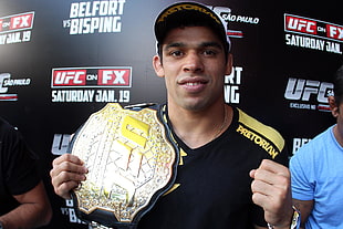 man holding UFC champion belt