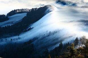 timelapse photo of mist on green mountain during daytime HD wallpaper