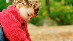baby wearing red sweater focus photo HD wallpaper