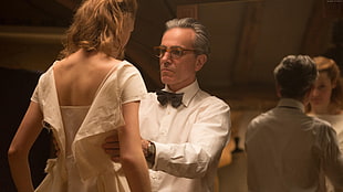 man wearing white dress shirt holding the woman wearing white dress