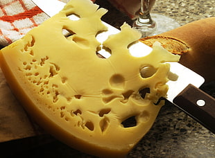 sliced cheese over knife and french bread