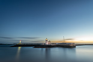 photography of lighthouse beside seashore during nighttime, howth, dublin, ireland
