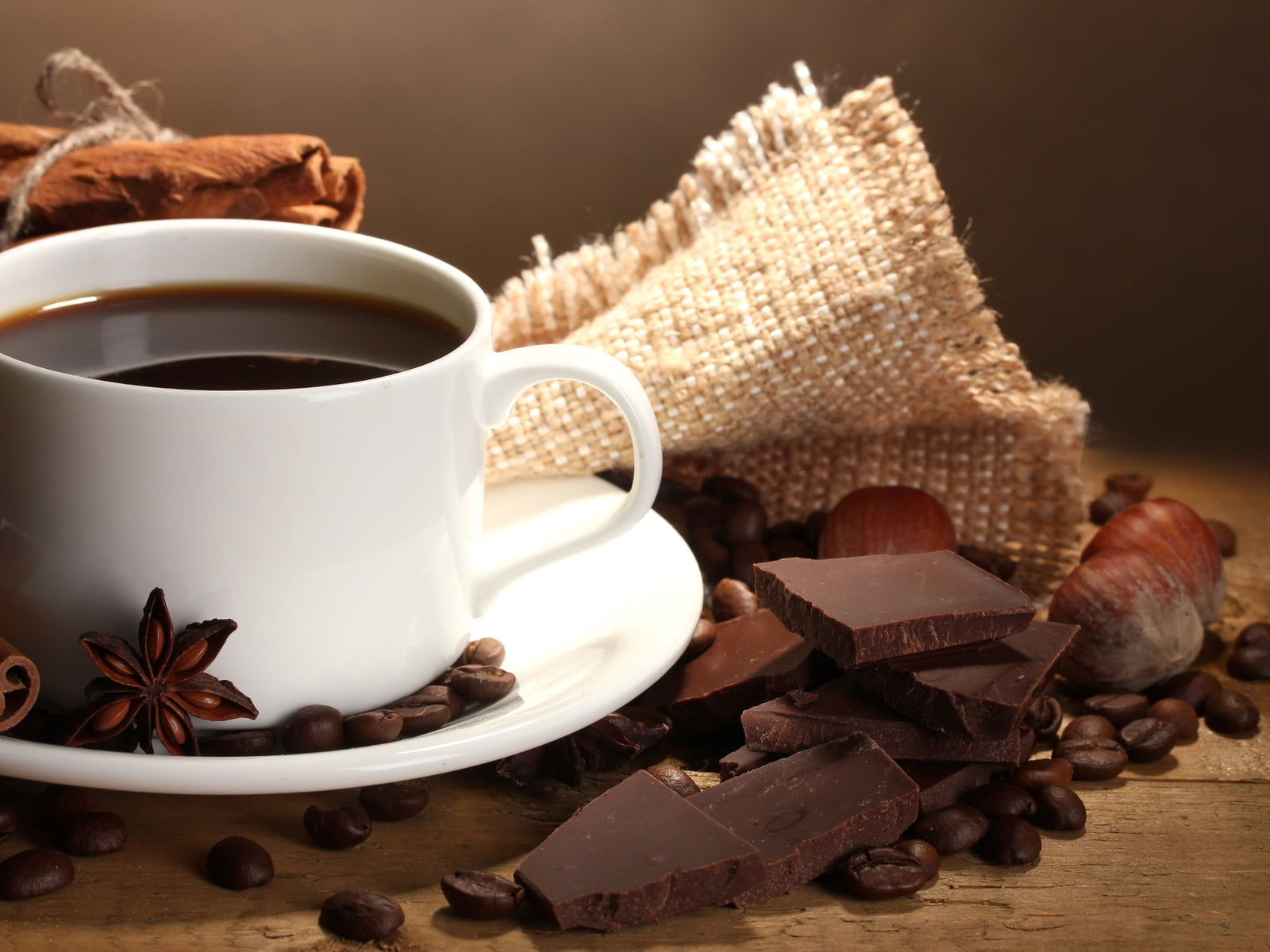 white ceramic teacup filled with coffee