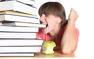 woman eating apple and book HD wallpaper