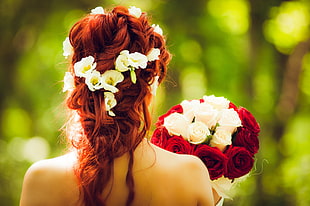selective focus photography of bridge carrying bouquet of white and red roses