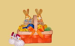 brown rabbit and white hen party favor in woven orange and brown basket