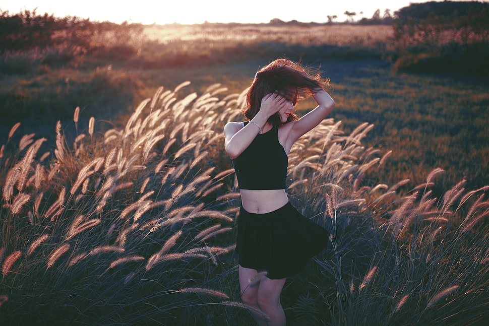 woman in black crop top and skirt surrounded by grass field during daytime HD wallpaper