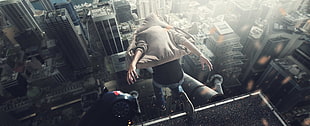 person attempting to jump on high-rise building taken during daytime HD wallpaper