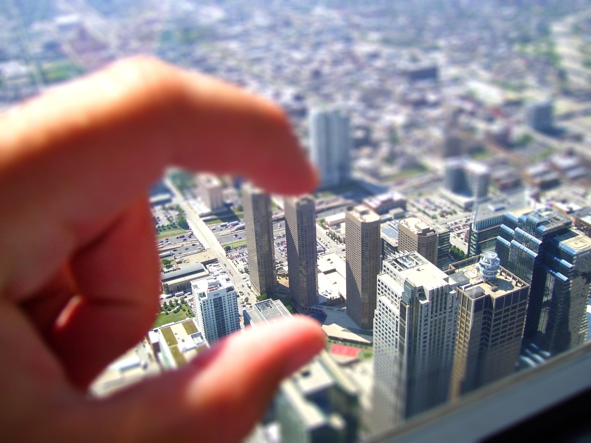 3D photography of person holding high-rise buildings