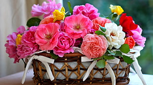 assorted flowers on brown wicker basket