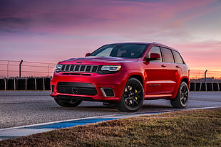 red Jeep Grand Cherokee on race track HD wallpaper