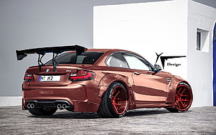 brown sports coupe with spoiler