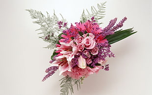 pink and purple corsage in front of white wall