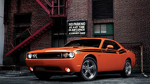 orange Dodge Challenger parked near building HD wallpaper