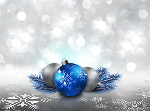 three grey and blue christmas baubles