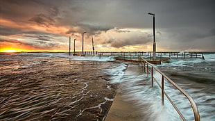time-lapse photography of sea waves on walkway