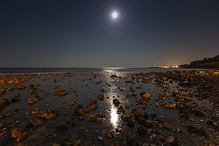 brown pebbles on shire during night, la playa