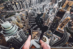 pair of black running shoes, rooftopping, aerial view, cityscape