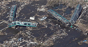 two green-and-black train toys, Tsunami