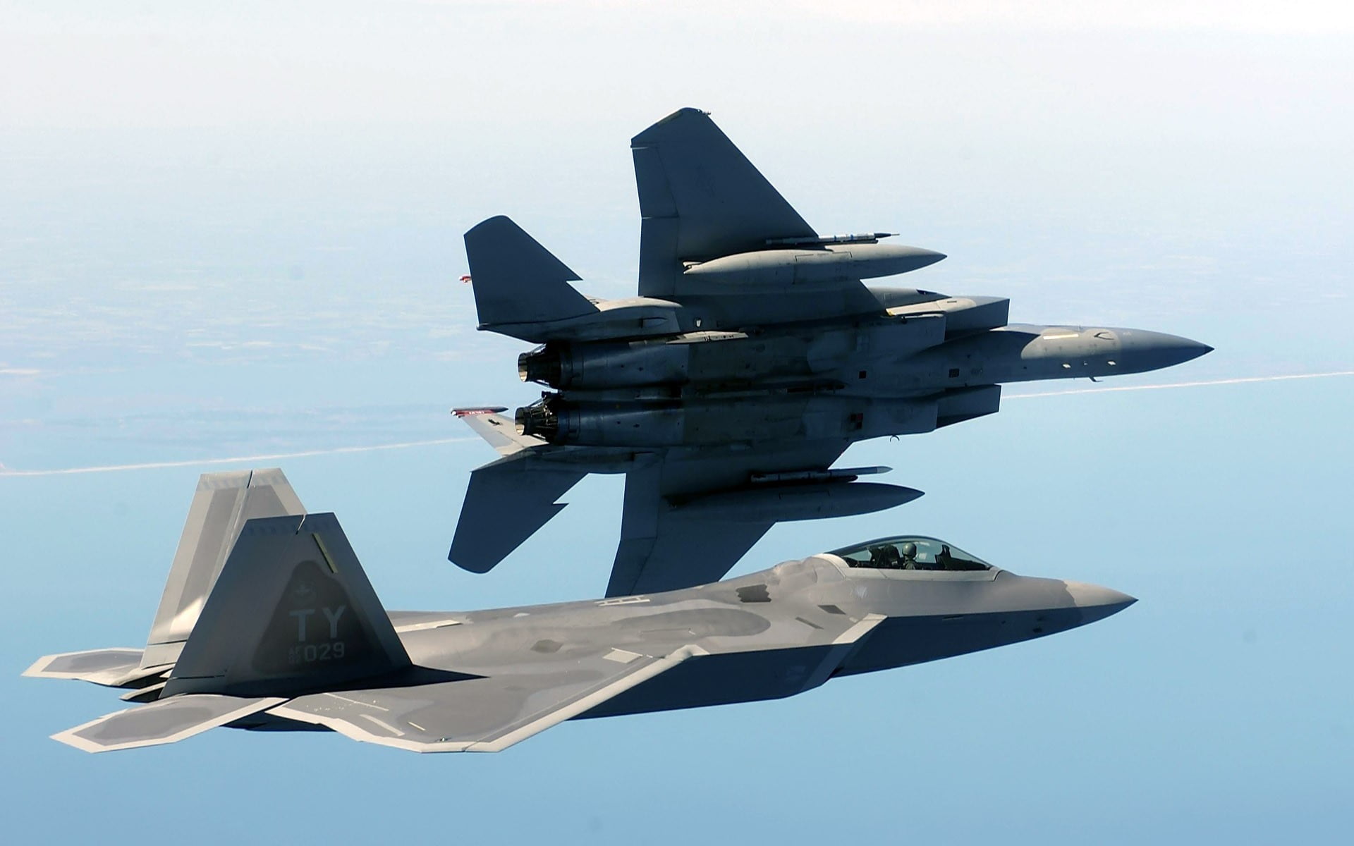two gray fighter planes, F-22 Raptor, F-15 Eagle, military aircraft