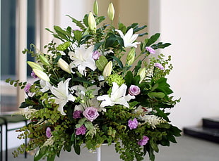 white and purple flowers bouquet with white metal stand