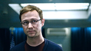 selective focus photography of man wearing black-framed eyeglasses