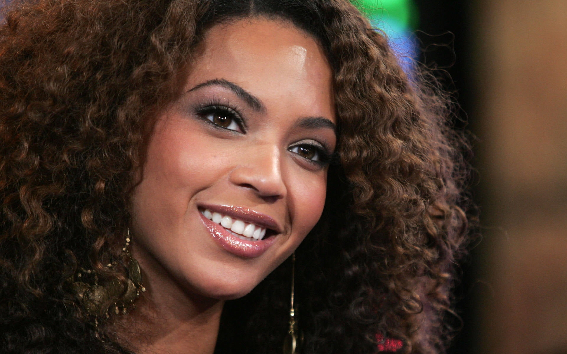 woman smiling with earrings