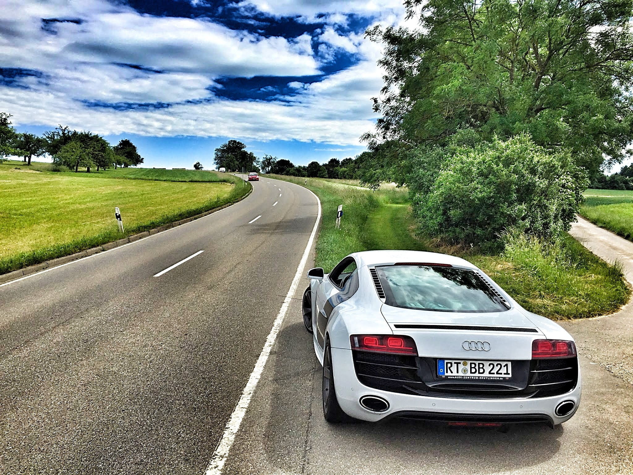 white audi sports car near green grass