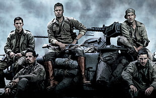 group of soldier sitting near machine guns HD wallpaper