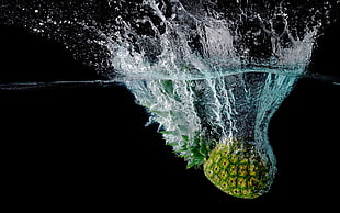 time lapse photography of pineapple dropped on water