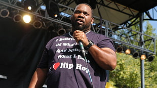 man wearing black crew-neck shirt and microphone