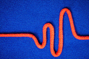orange rope on top of blue textile