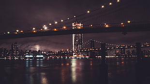 lighted Brooklyn Bridge at night