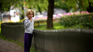 boy's gray hoodie near fence
