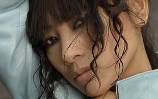 closeup photo of woman wearing teal top