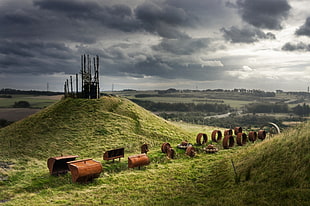 brown steel container on green hill under gray cloudy sky HD wallpaper