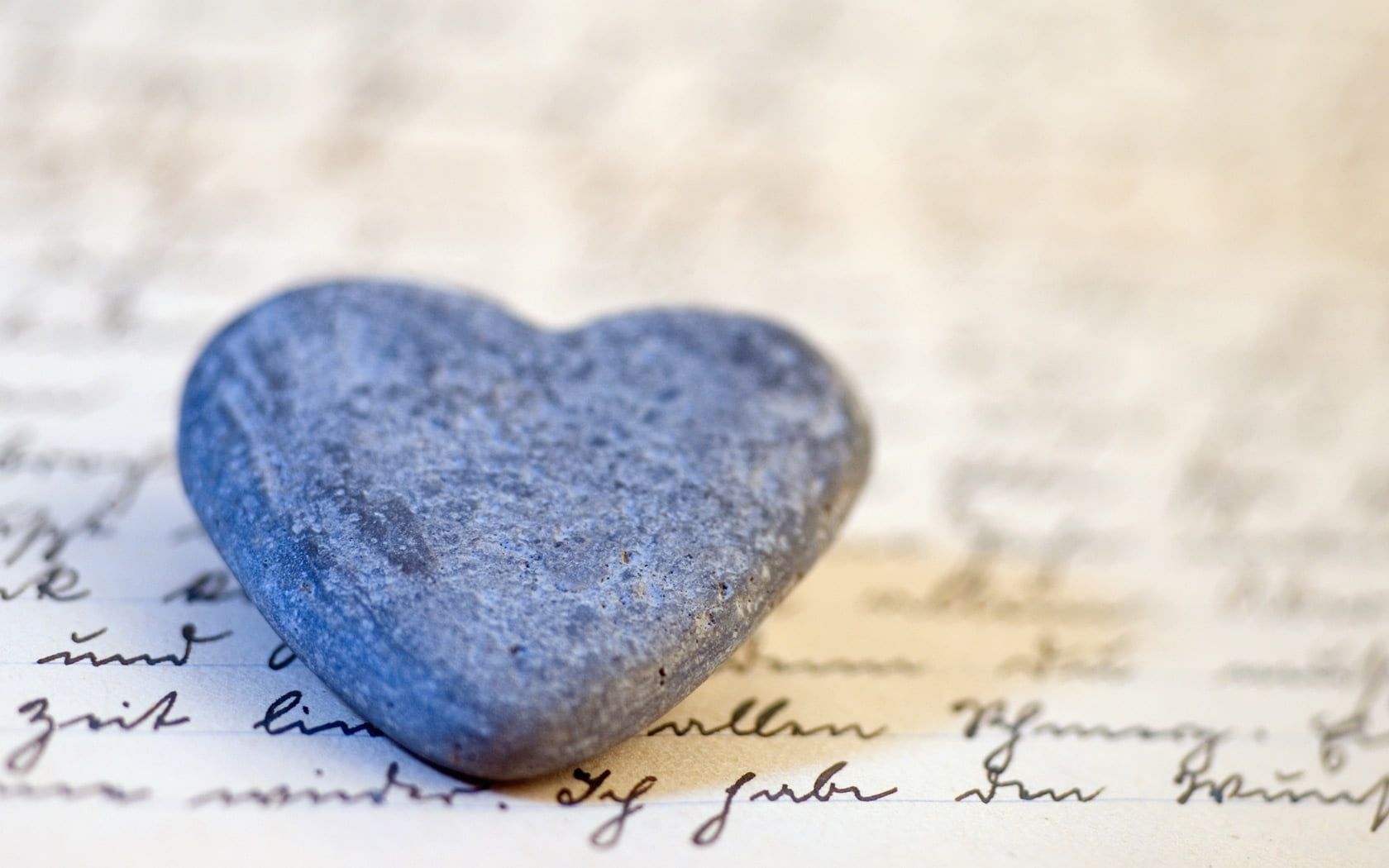 black heart stone fragment on white printed paper