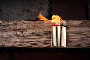 time lapse photo of matchsticks on fire on wooden board