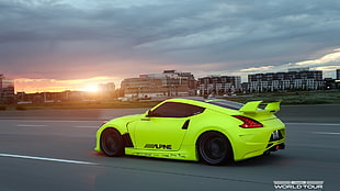 green Nissan 370z on road during golden hour