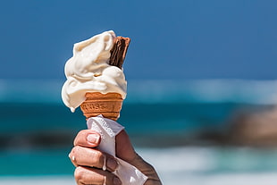 white melted vanilla ice cream with chocolate bar photo