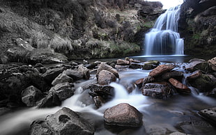 water falls with rocks during daytime