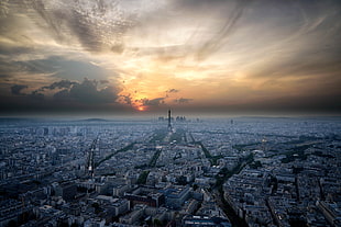 aerial view of city at sunset and cloudy skies, paris, montparnasse tower