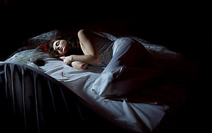 woman laying on white bedding
