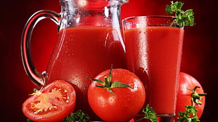 clear glass pitcher and clear drinking glass with tomato juice