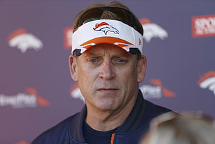man wearing white Denver Broncos sunvisor hat